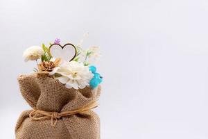 Artificial flowers in Sack on background photo