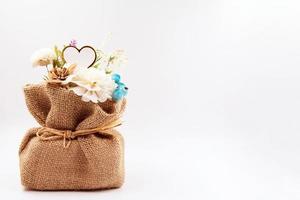 Artificial flowers in Sack on background photo