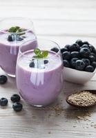 Glasses of blueberry yogurt with blueberries photo