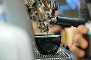 espresso shot from coffee machine in coffee shop photo