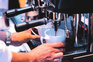 espresso shot from coffee machine in coffee shop photo