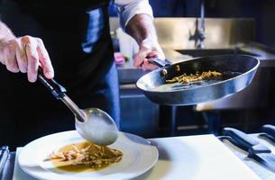 Chef preparing food in the kitchen, chef cooking, closeup photo