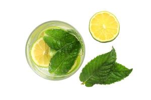 A glass with a lime and mint drink on an isolate against photo