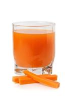 Carrot juice in a transparent glass with pieces of carrot photo