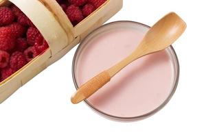 Raspberry yogurt in a glass cup with raspberry basket photo