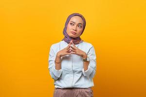 Beautiful Asian woman thinking and interested looking up photo