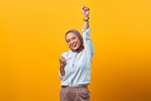 Portrait of excited Asian woman celebrating luck photo