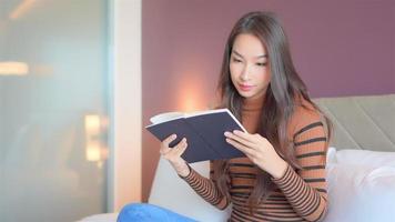 joven, mujer asiática, leer un libro video