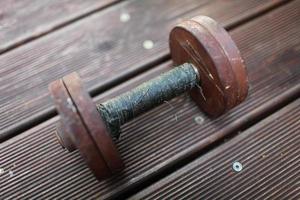 heavy steel dumbbell, handle rewound with black duct tape photo