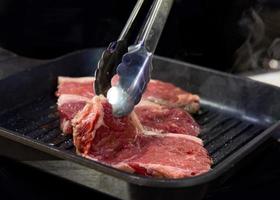 Beef fillet on grill , Beef steaks being prepared on grill photo