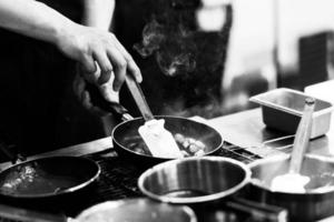 Chef cooking in the kitchen, Chef decorating dish, closeup photo