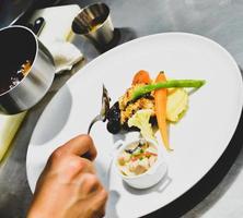 Chef preparing food in the kitchen, chef cooking, Chef decorating dish photo