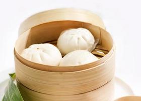 Chinese steamed pork buns, Steamed bun served in wooden basket photo