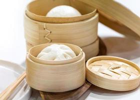 Chinese steamed pork buns, Steamed bun served in wooden basket photo