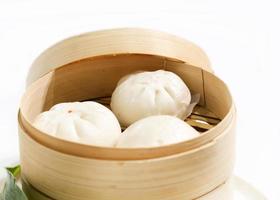 Chinese steamed pork buns, Steamed bun served in wooden basket photo