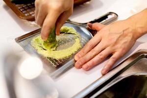 Sushi chef grating fresh Wasabi, Fresh wasabi root photo