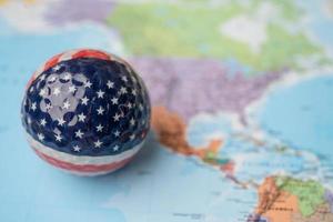 USA America map at golf ball with flag on world globe map. photo