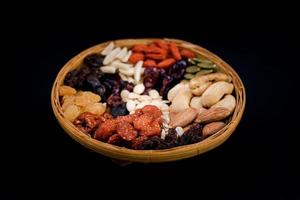 Group of various types of dried fruits and dried on a bamboo tray. photo