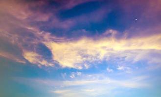 Crescent moon and clouds in the sky photo