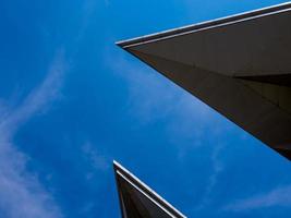 Exotic shapes of roof of the modren building and bright blue sky photo