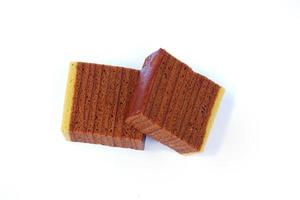 Chocolate layered sponge cake isolated on a white background photo