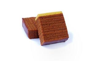 Chocolate layered sponge cake isolated on a white background photo