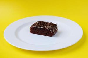 Sponge cake on white plate isolated photo