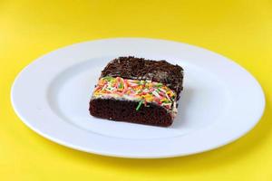 Sponge cake on white plate isolated photo