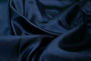 Closeup of smooth elegant black silk fabric luxury cloth texture photo
