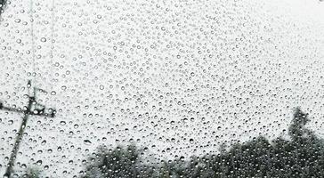 Rain drops on car window background photo