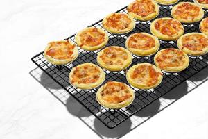 Mini pie from meat and mushrooms in metal tray photo