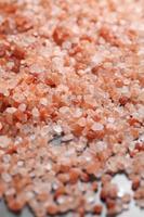 Close up a pile of Himalayan pink salt in natural light photo