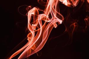 Smoke floating on dark background photo