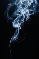 Smoke floating on dark background photo