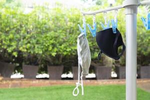 Face mask hang outside house to dry and resued photo