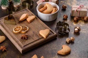 Christmas frame with fir tree branches, gingerbread cookies photo