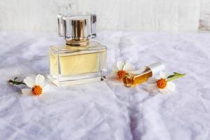 Golden perfume and perfume bottles on white background photo