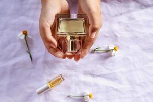 Golden perfume bottle in hand photo
