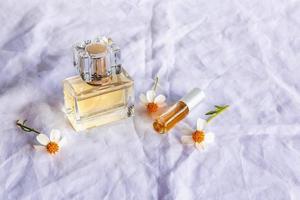 Golden perfume and perfume bottles on white background photo