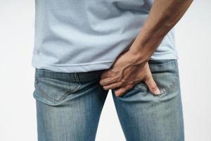 Man hold his bottom because Diarrhea, Hemorrhoids, constipation. photo