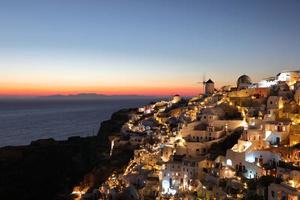 Beautiful sunset at oia on Santorini Island, Greece photo