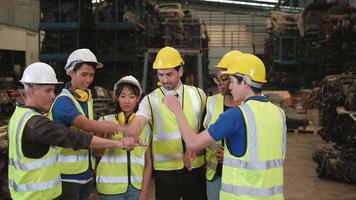 Group of enginners in uniforms and helmets in warehouse. video