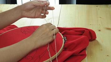 Embroider sewing by woman hand. Craft work and female hands. photo