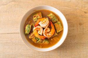 Sour soup made of Tamarind Paste with Shrimps and Vegetable Omelet photo