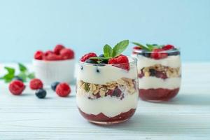 Homemade raspberry and blueberry with yogurt and granola photo