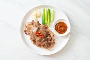 Grilled pork neck sliced on plate photo