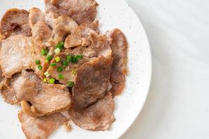 Grilled pork neck sliced on plate photo