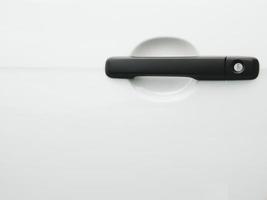 Black car door handle on white vehicle automotive car photo