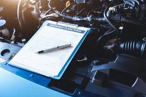 Clipboard with car insurance claim form for customer maintenance photo