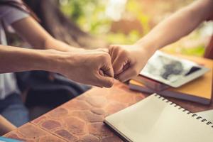 Business partnership giving fist bump to start up new project photo